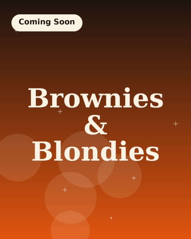 Stacked fudgy brownies with crackly tops and imperfect cut edges
