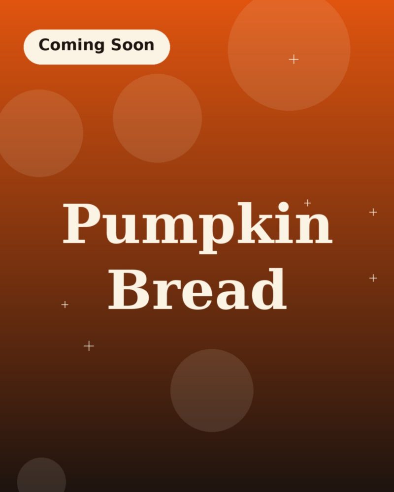 Sliced pumpkin bread on parchment with a crackled top crust